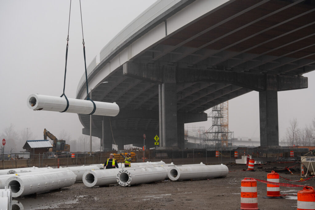 workers lifting metal with crane