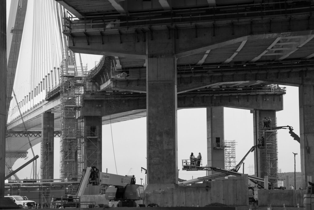 black and white construction workers in booms