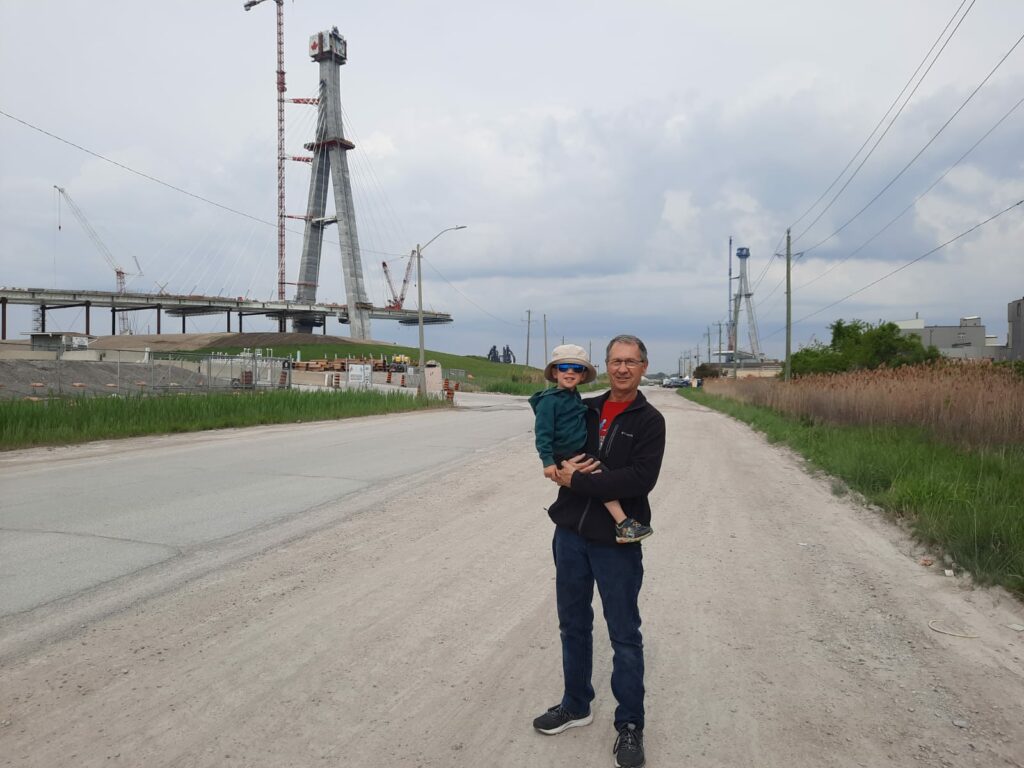 Lucas and his grandfather Jeff Marshall see construction begin on the Gordie Howe International Bridge deck over the Detroit River on May 19, 2023.