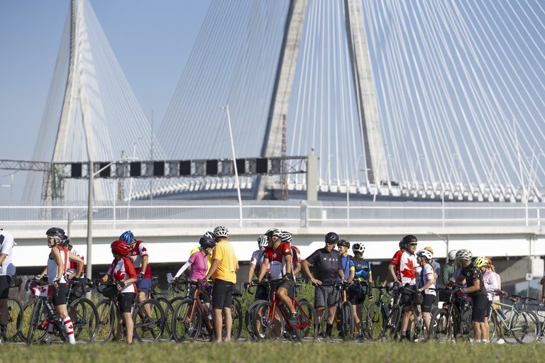 Cyclists await the multi-use path opening August 5, 2026.